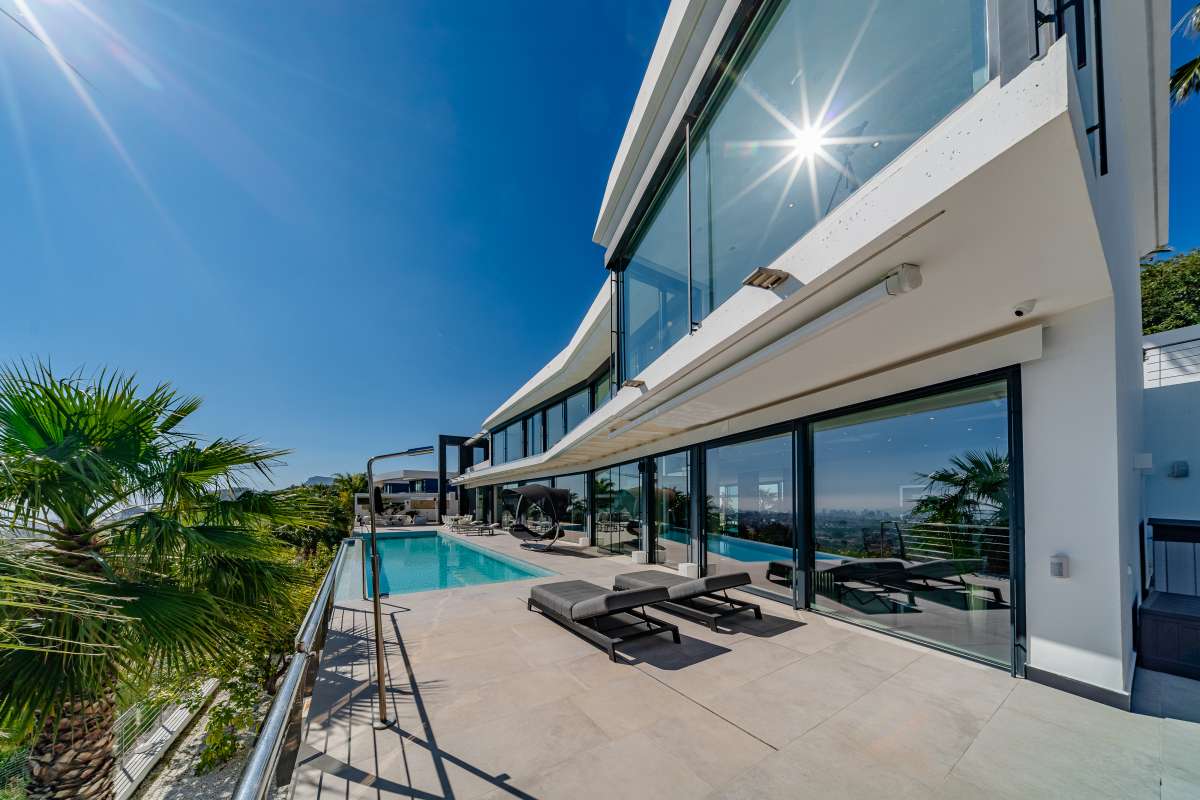 Sea view pool terrace with sun loungers, contemporary architecture and panoramic views at a luxury villa in Gran Sol, Calpe.