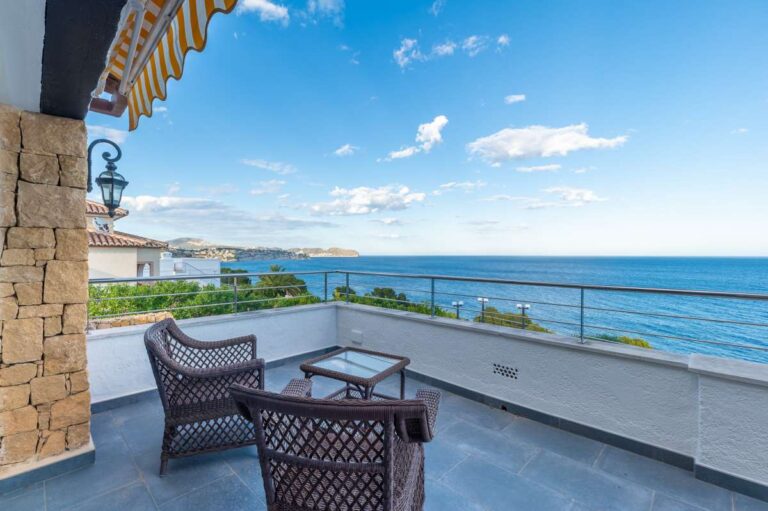 Sea-view terrace at a premium coastal villa on the Benissa Costa with outdoor seating, glass railing and panoramic Mediterranean views