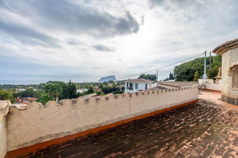 Sea views and Peñón de Ifach views from the upper terrace of a finca-style villa in Benissa Costa with tiled flooring and stone details