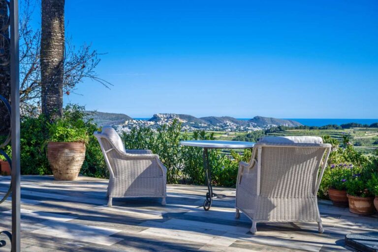 Sea views from an outdoor terrace at a traditional Spanish finca near Moraira with seating area, countryside views and Mediterranean coastline beyond