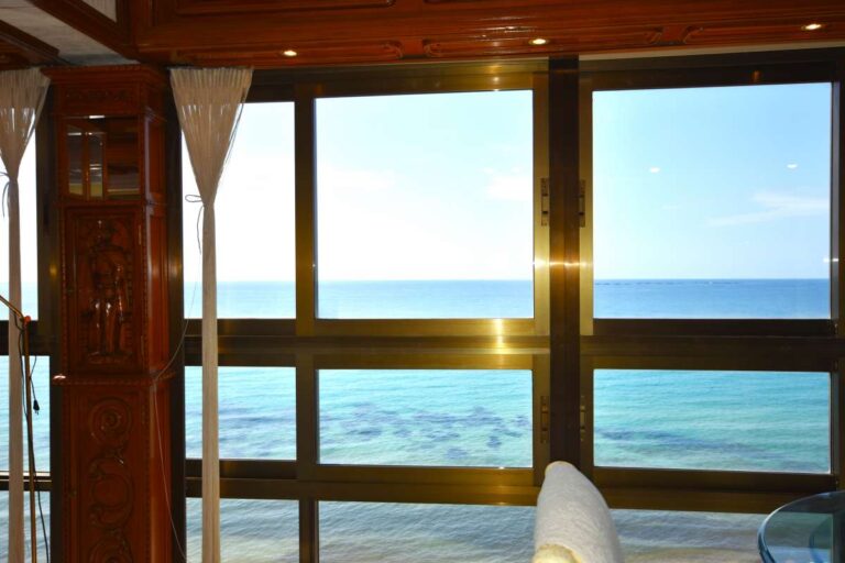 Sea views through large glazed windows from a frontline double penthouse on Arenal Beach in Calpe.