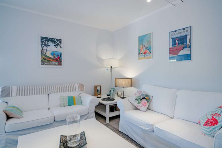 Second living room inside a modern villa for sale in Calpe with sofa seating, coffee table and bright interior design