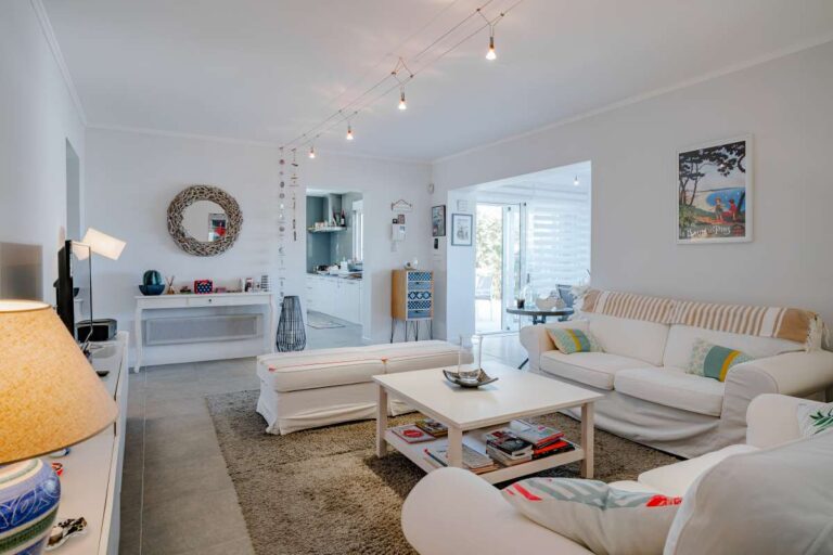 Second living room inside a modern villa in Calpe with sofa seating, TV unit and bright interior space