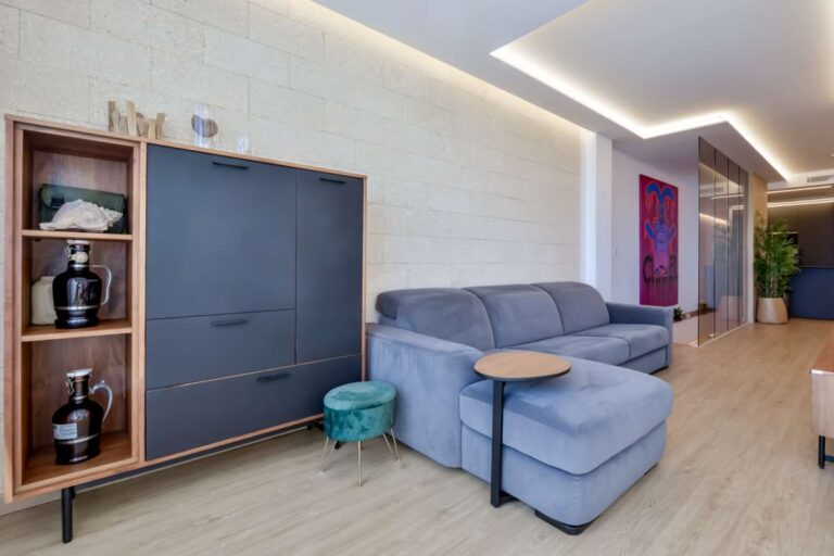 Second lounge area inside a luxury frontline beach duplex in Mascarat, Altea with sofa seating, built-in storage and bright modern interior
