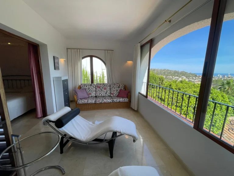 SEO alt text: Master bedroom lounge area with panoramic sea views inside a villa in Empedrola, Calpe.