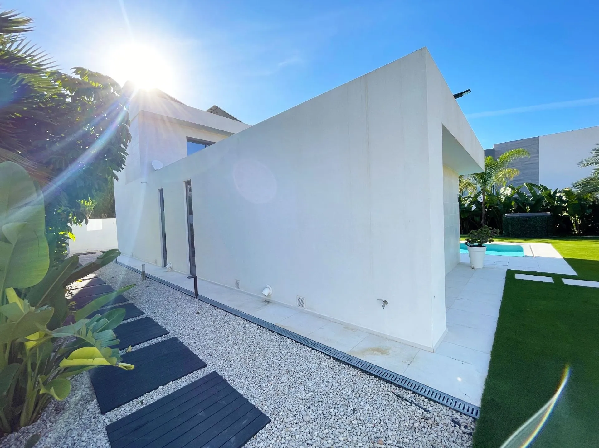 Side exterior and pool area at modern villa in Calpe