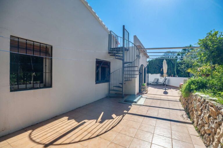 Side exterior of a Mediterranean villa in Benissa Costa near Cala Baladrar with terrace, exterior stairs to the solarium and garden access