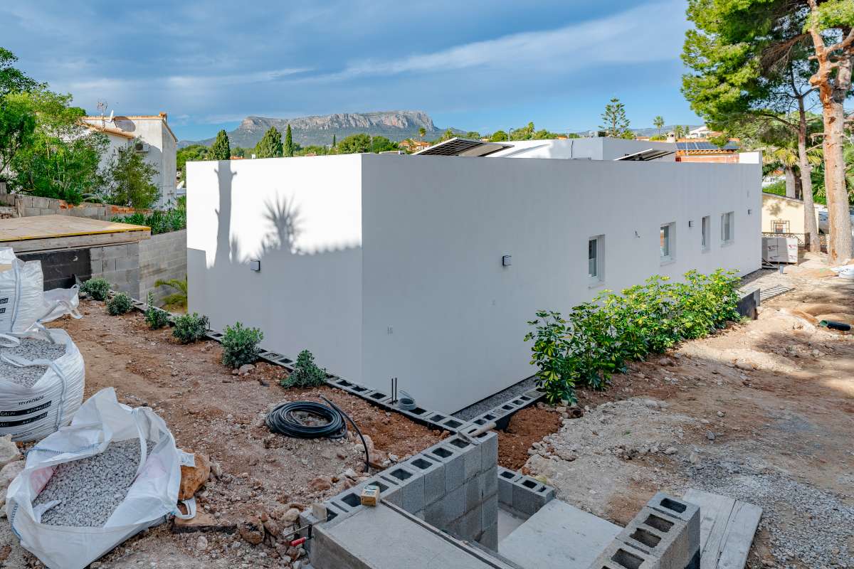 Side exterior of a new build villa in Calpe with private garden area and surrounding mountain views