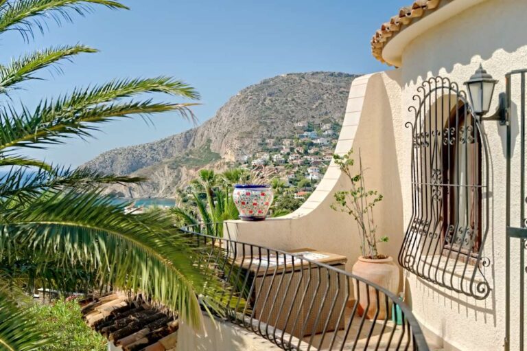 Side terrace with mountain views and Mediterranean-style exterior at a second line villa near Puerto Blanco in Calpe.