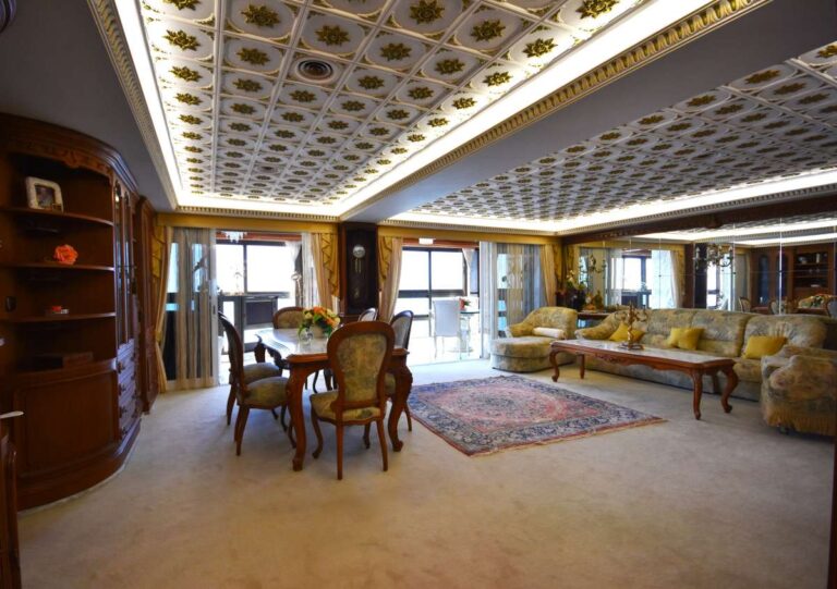 Spacious living and dining area with quality finishes inside a frontline double penthouse for sale on Arenal Beach in Calpe.