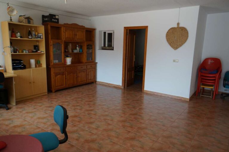 Spacious living area with traditional wooden furniture inside a Mediterranean villa in Calpe.