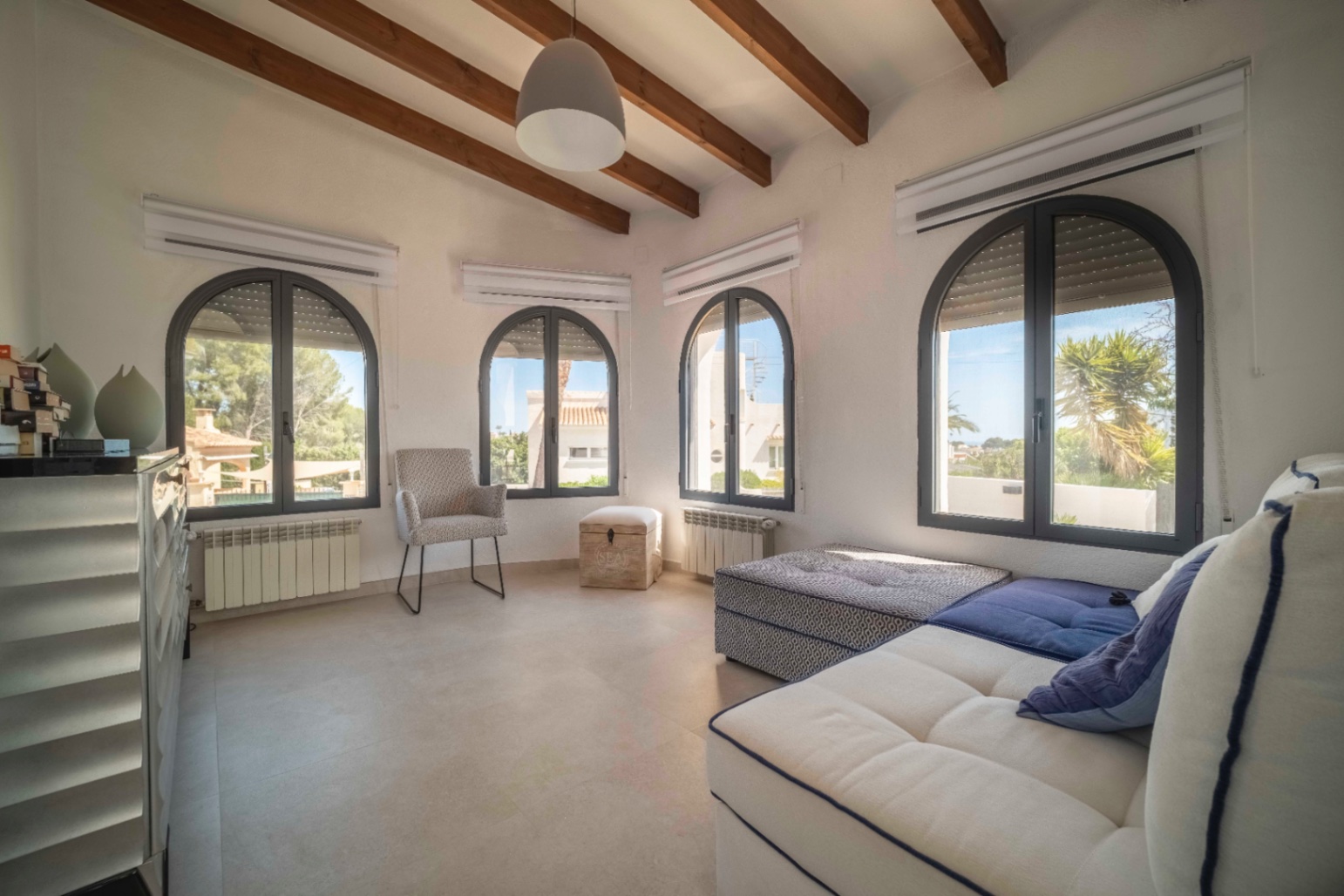 Spacious living room with arched windows at villa in Calpe