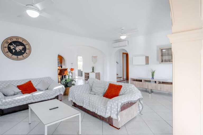 Spacious lounge area in a Calpe villa with sofas, tiled flooring and natural light