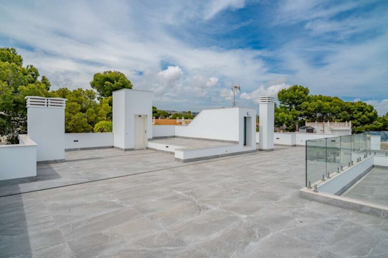 Spacious roof terrace at a modern villa in La Calalga, Calpe with glass balustrades, open views and contemporary outdoor space
