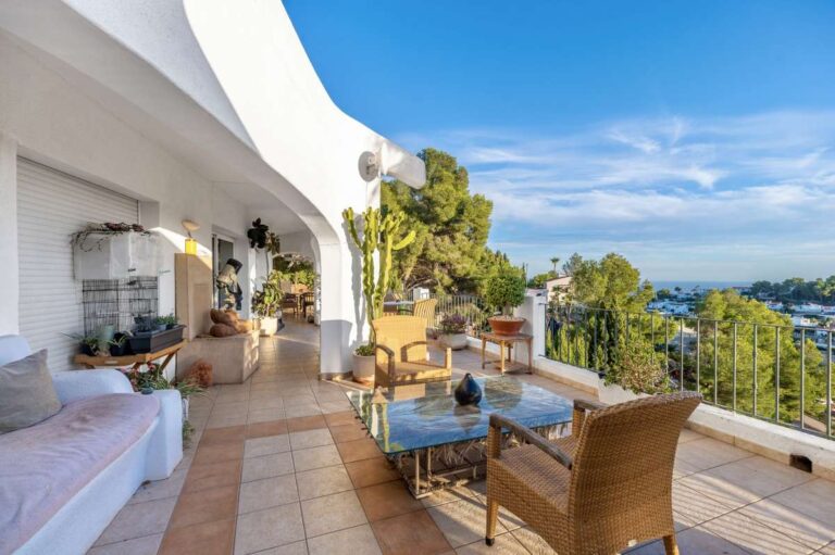 Spacious terrace at a panoramic sea view villa in Benissa with outdoor seating, arched architecture and views across the coastline