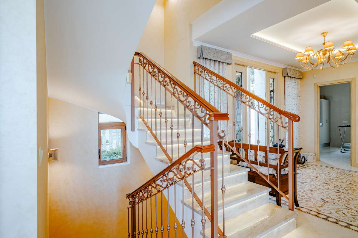 Staircase leading to the living area inside a frontline villa with sea views in Les Bassetes.