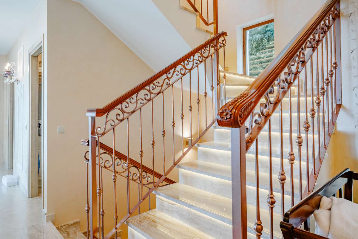 Staircase with wooden handrail and bright interior finish inside a frontline villa in Les Bassetes, Benissa Coast.