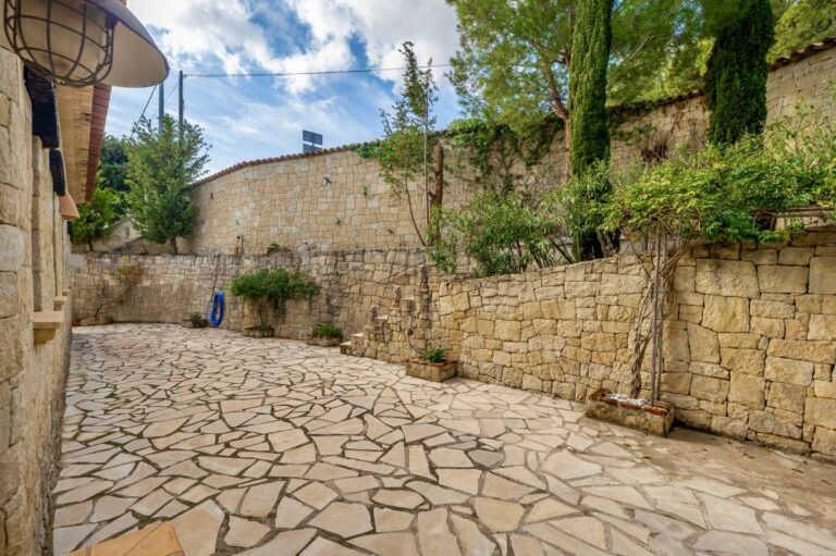 Stone courtyard at a finca-style villa in Benissa Costa with paved outdoor area, natural stone walls, mature planting and private exterior space