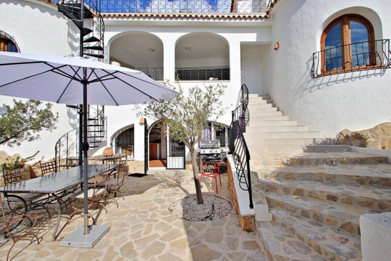 Stone courtyard with steps and outdoor seating at Moraira villa
