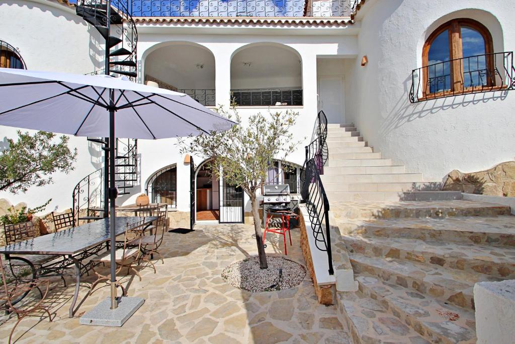 Stone courtyard with steps and outdoor seating at Moraira villa