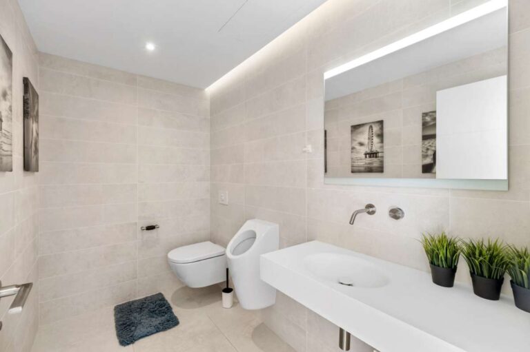 Stylish family bathroom with bath, vanity and natural light inside a modern oasis villa in Calpe.