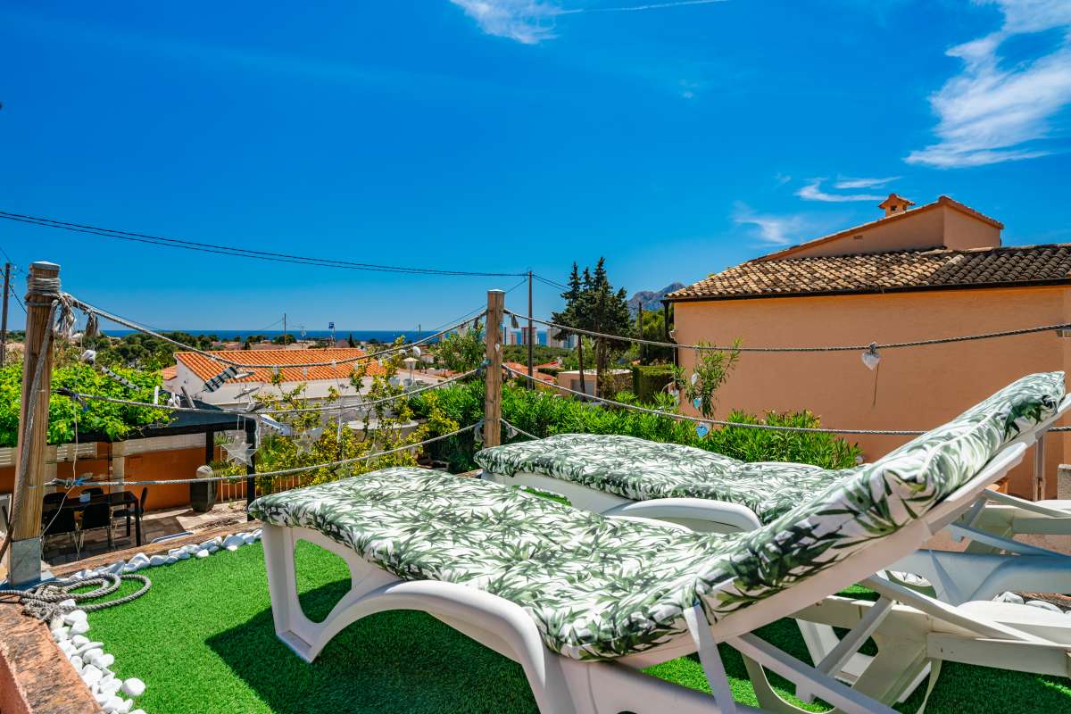 Sun lounger area overlooking the garden and surrounding area at a renovated Mediterranean villa in La Cometa, Calpe.