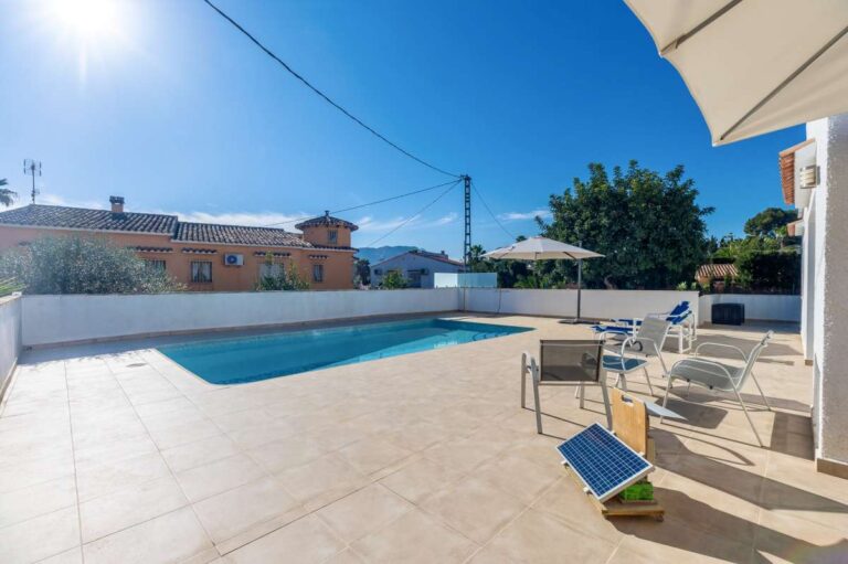 Sunny pool terrace with outdoor seating at a contemporary villa with private swimming pool in Calpe.