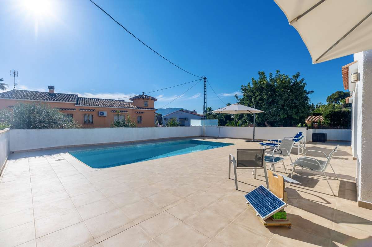 Sunny pool terrace with outdoor seating at a contemporary villa with private swimming pool in Calpe.