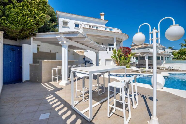 Sunny terrace with outdoor seating and sea views at a villa in Calpe.