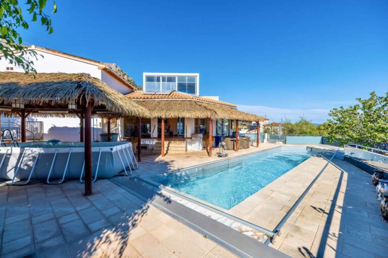 Swimming pool terrace at a private villa in Calpe with covered outdoor seating, Mediterranean sea views and generous outdoor space