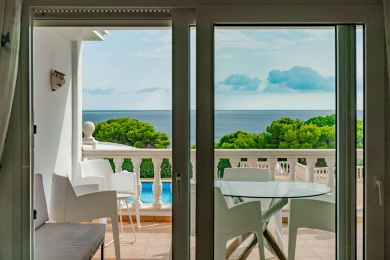 Terrace access from a duplex apartment near Les Platgetes Beach in Moraira with sea views, outdoor dining area and communal pool views