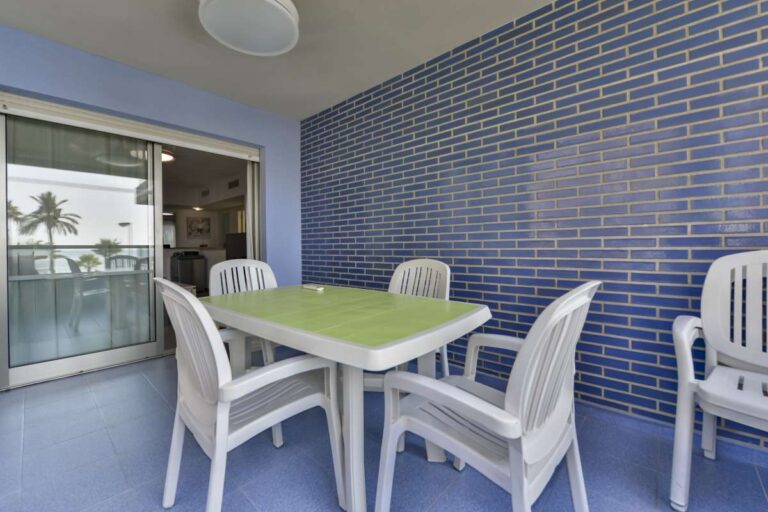 Terrace dining area at a frontline La Fossa apartment in Calpe with sliding doors and outdoor seating