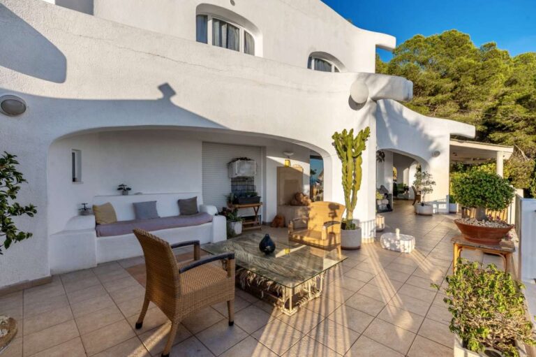 Terrace exterior at a Benissa villa with outdoor lounge seating, white Mediterranean architecture and panoramic views towards Calpe