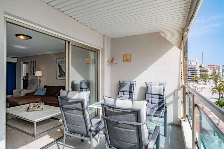 Terrace lounge at a beachfront apartment by La Fossa Beach in Calpe with outdoor seating, covered balcony and living room access