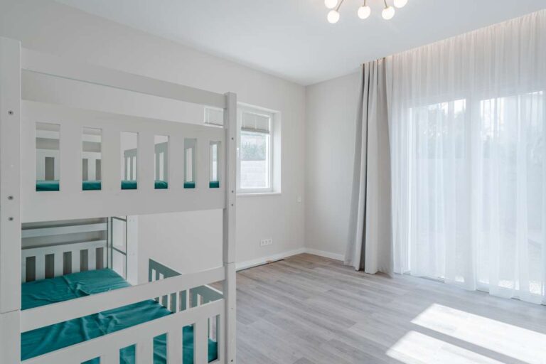 Twin bedroom with bunk beds and large window inside a new build three bedroom villa in Calpe