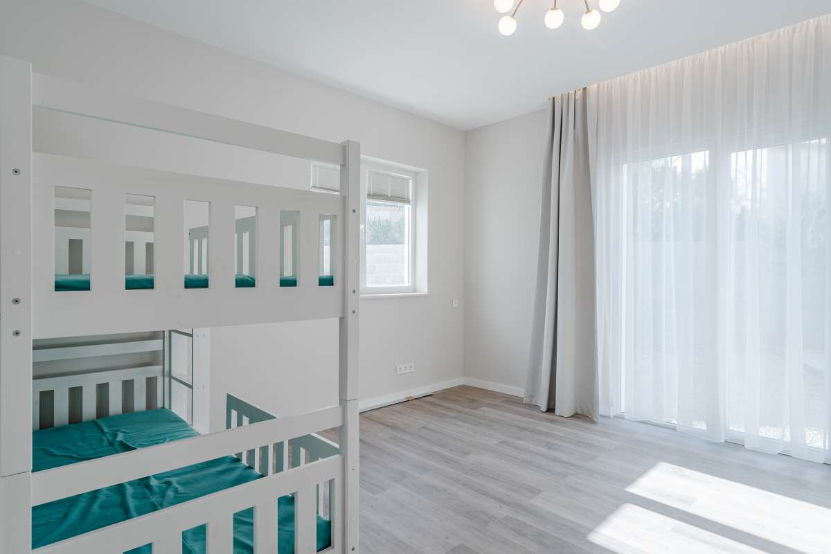 Twin bedroom with bunk beds and large window inside a new build three bedroom villa in Calpe
