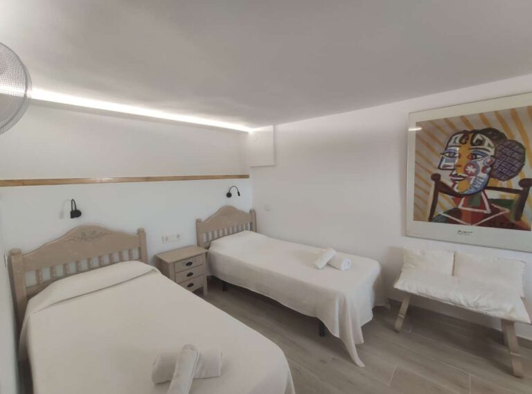 Twin bedroom with light interior and wall art inside a refurbished villa in Canuta, Calpe.