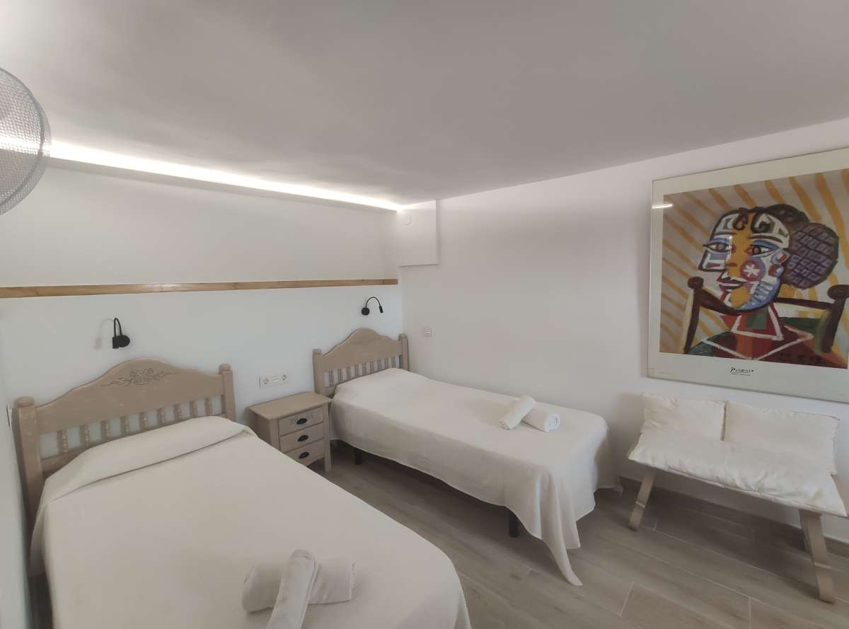 Twin bedroom with light interior and wall art inside a refurbished villa in Canuta, Calpe.