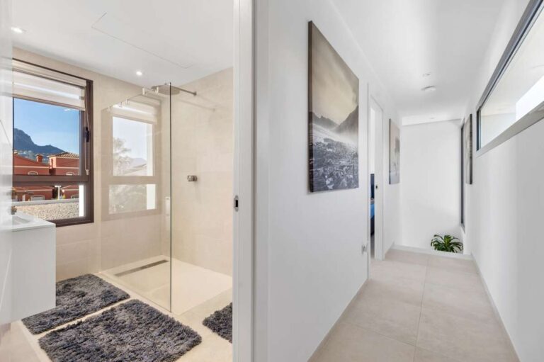 Upper floor landing with natural light and access to bedrooms inside a modern oasis villa in Calpe.