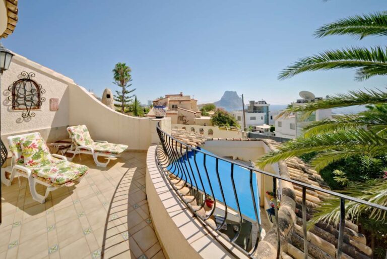 Upper floor terrace with sea views, sun loungers and curved railing at a second line Mediterranean villa near Puerto Blanco in Calpe.