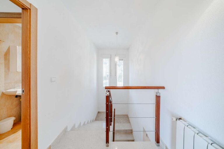 Upper hallway inside a semi-detached house in Calpe with staircase access and bright interior