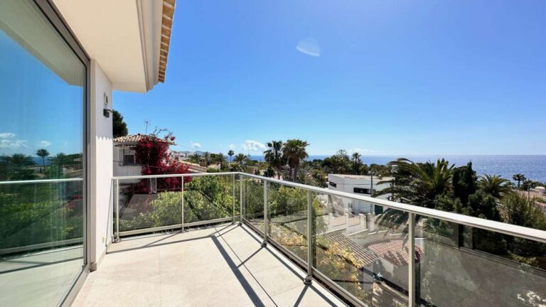 Upper terrace at a modern luxury villa in La Calalga, Calpe with glass railing, sea views and surrounding residential views