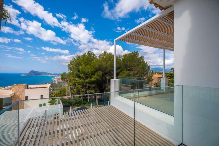 Upper terrace at a modern villa in Altea Hills with glass railing, pergola, Mediterranean Sea views and mountain views