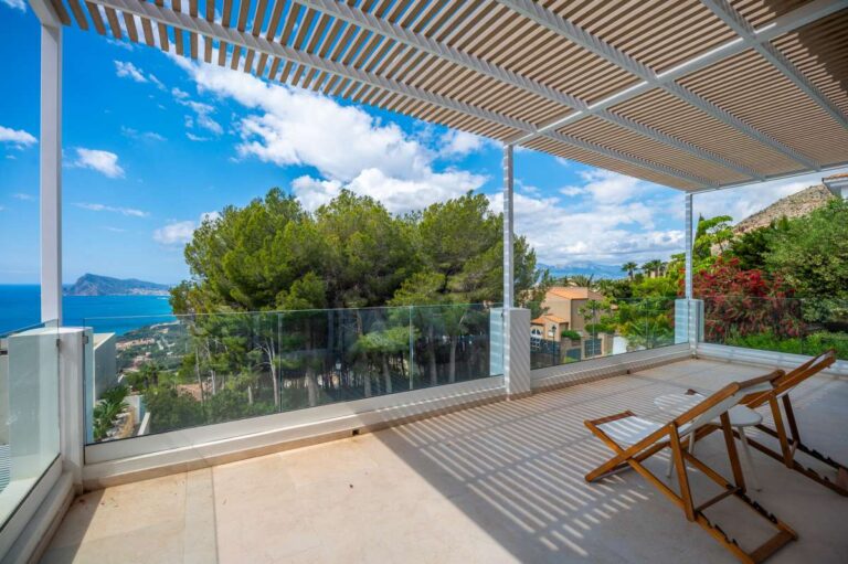 Upper terrace at a modern villa in Altea Hills with pergola, glass railing, sea views, mountain views and outdoor seating