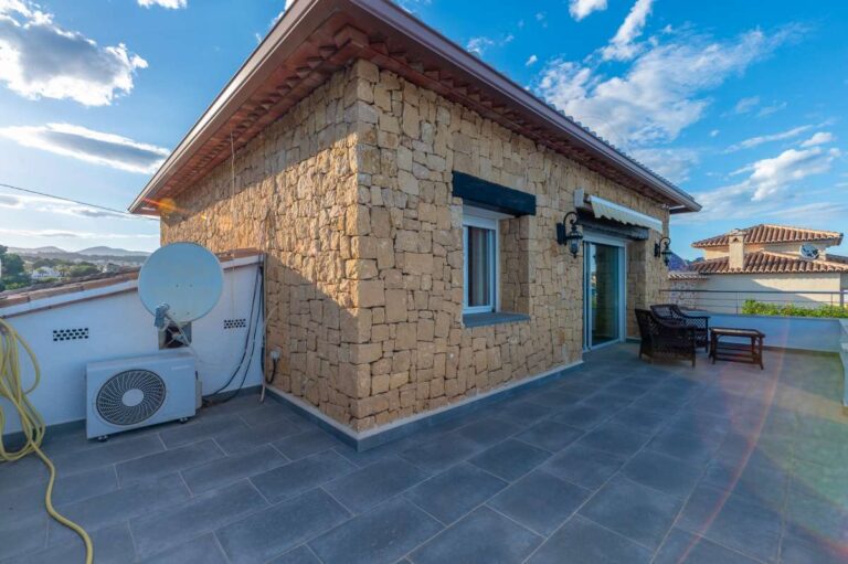 Upper terrace at a premium coastal villa on the Benissa Costa with stone exterior, outdoor seating and open views across the surrounding area
