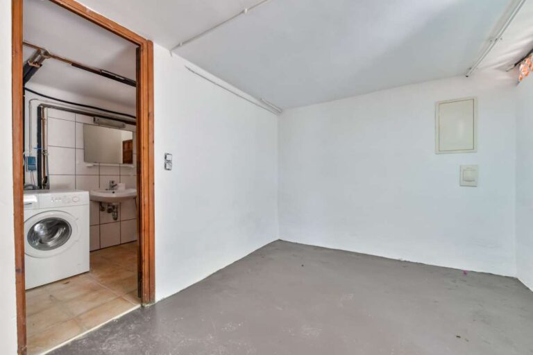 Utility and storage room inside a charming Benissa Coast villa with laundry access, open floor space and potential for further use