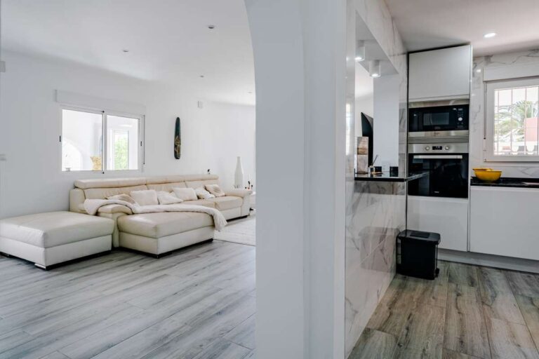 View from the living room towards the open-plan kitchen inside a renovated Mediterranean villa in La Cometa, Calpe.
