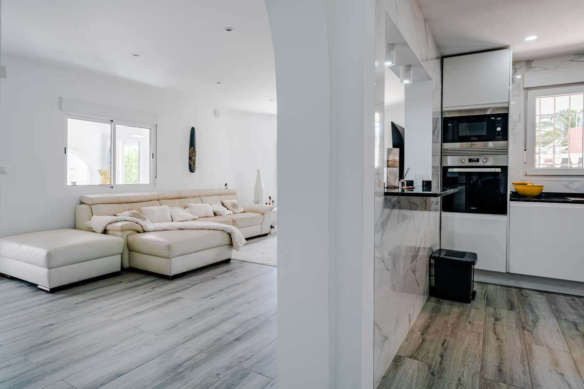 View from the living room towards the open-plan kitchen inside a renovated Mediterranean villa in La Cometa, Calpe.