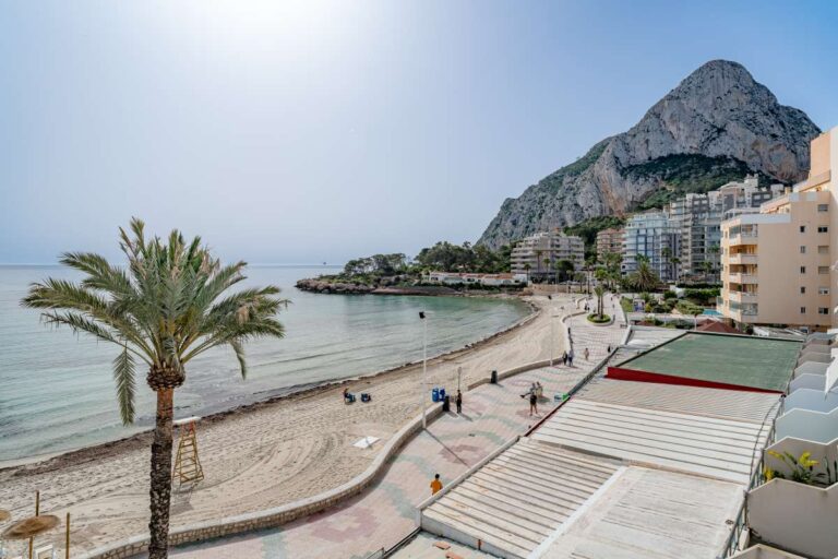 Views from a beachfront apartment by La Fossa Beach in Calpe showing the Peñón de Ifach, palm tree, promenade and Mediterranean Sea