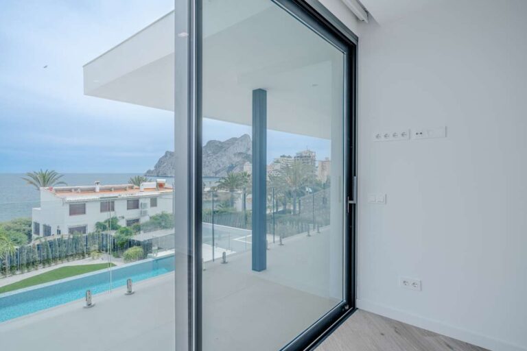Views from a bedroom inside a modern villa in La Calalga, Calpe overlooking the pool terrace, sea and Peñón de Ifach